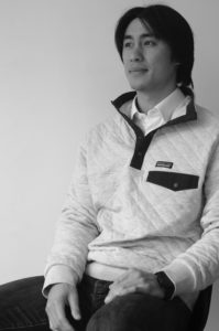 Kyle Yong in a Patagonia Sweater posing for the photo. Kyle was then interviewed about his research on role models of social entrepreneurs.